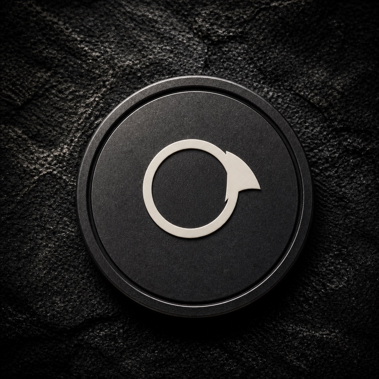 PEEL token — charcoal coin with the peel mark inlaid